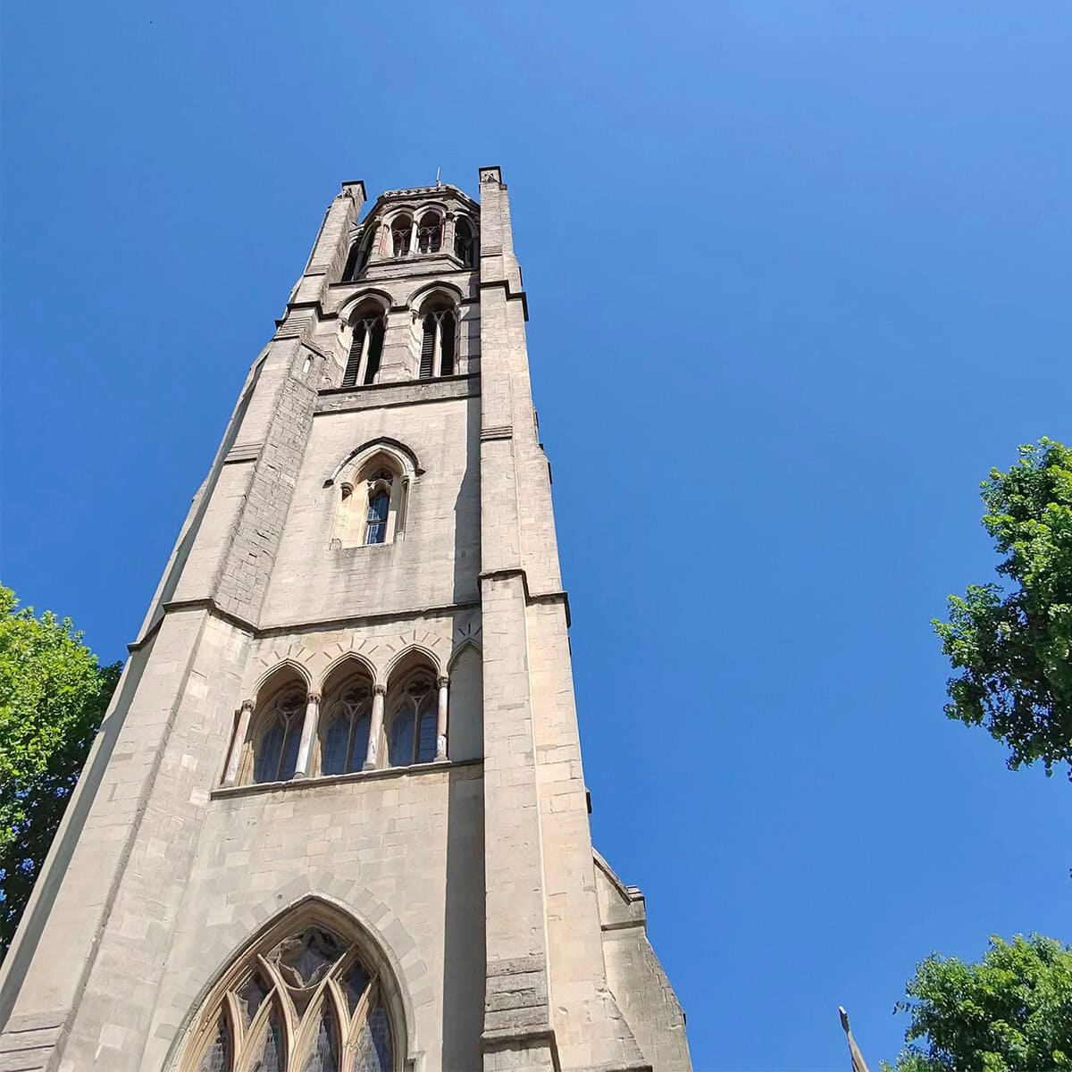 All Saints Church in Notting Hill, London – a peaceful historic landmark framed by trees and soft light