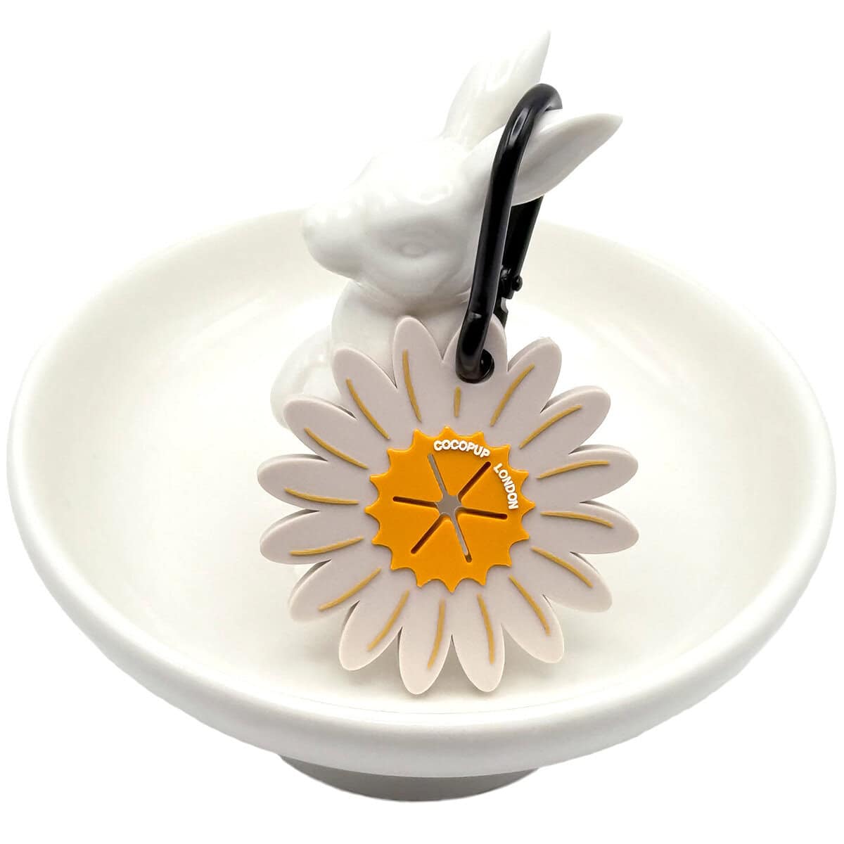 CP-DOG-0001-DAI_Poop Pocket_Daisy copy Cocopup London Daisy Poop Pocket, flower-shaped dog waste bag holder with yellow centre and white petals, shown with a black carabiner clip, displayed on a white ceramic rabbit dish.