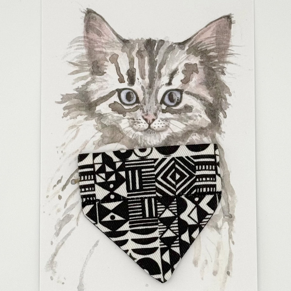 HW-CAT-0002_BD_Strech Cat Bandana_Card copy Hiro + Wolf Bow Wow Haus Cat Bandana in black and white geometric print, triangular fabric accessory displayed on a brand card featuring a hand-drawn cat illustration.