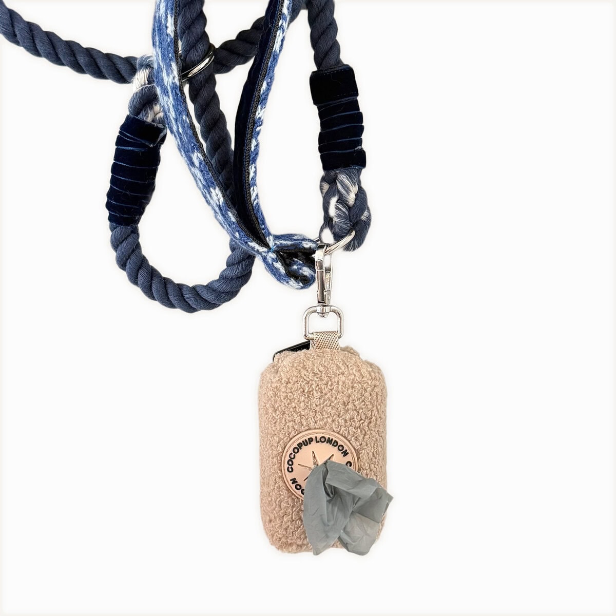 Poo_Bag_V2 copy Cocopup London Teddy Poop Bag Holder Rupert in beige fluffy fabric, attached to a blue rope dog lead, shown with a grey waste bag pulled through the dispenser.