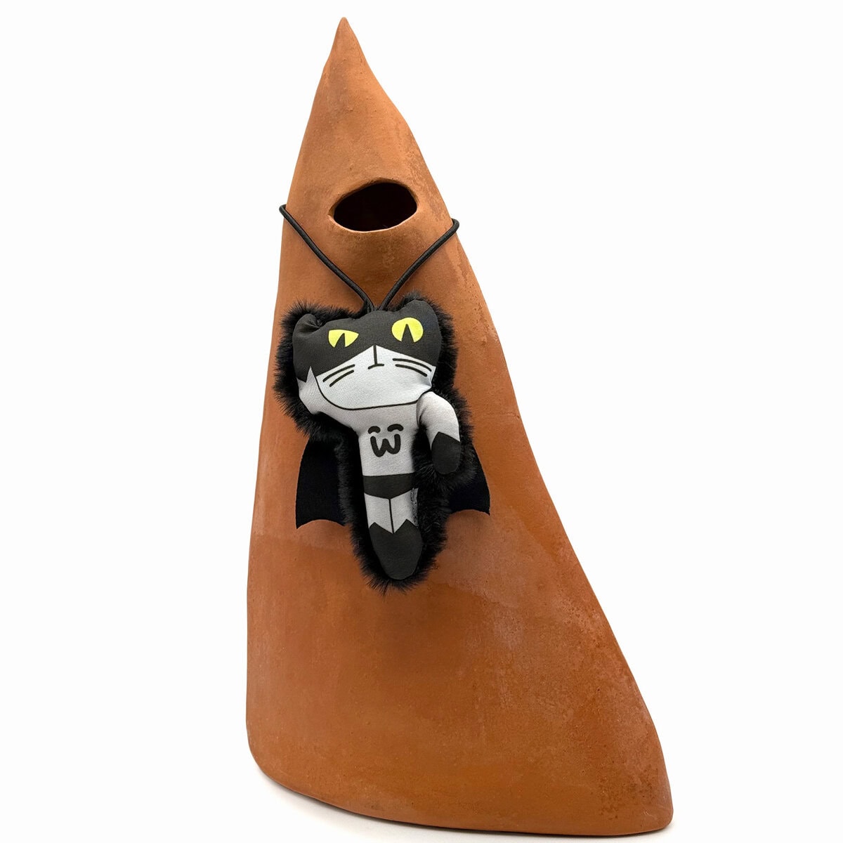 WW-CAT-0002-BAT_Image copy WufWuf Mymeow Batmeow Finger Teaser Cat Toy, plush bat cat character with yellow eyes and cape, displayed hanging on a terracotta ornament, shown in a styled image.