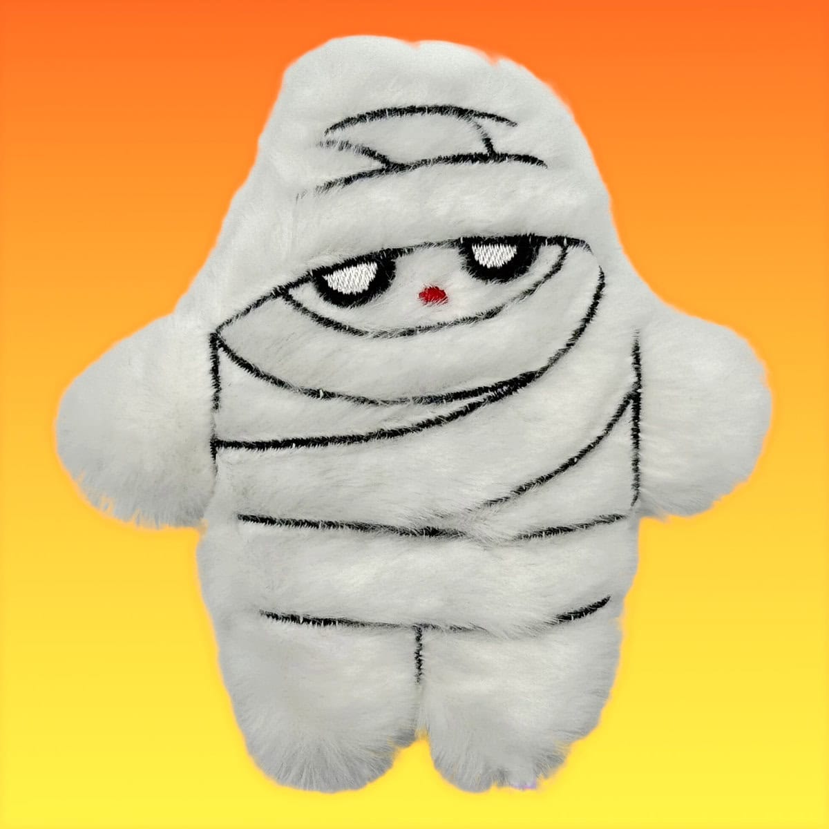 WW-CAT-0004-Mummy_Front Orange WufWuf Mymeow “My Mummy” refillable cat toy – white plush mummy character with stitched eyes and red nose, set against an orange-yellow gradient background for Halloween.