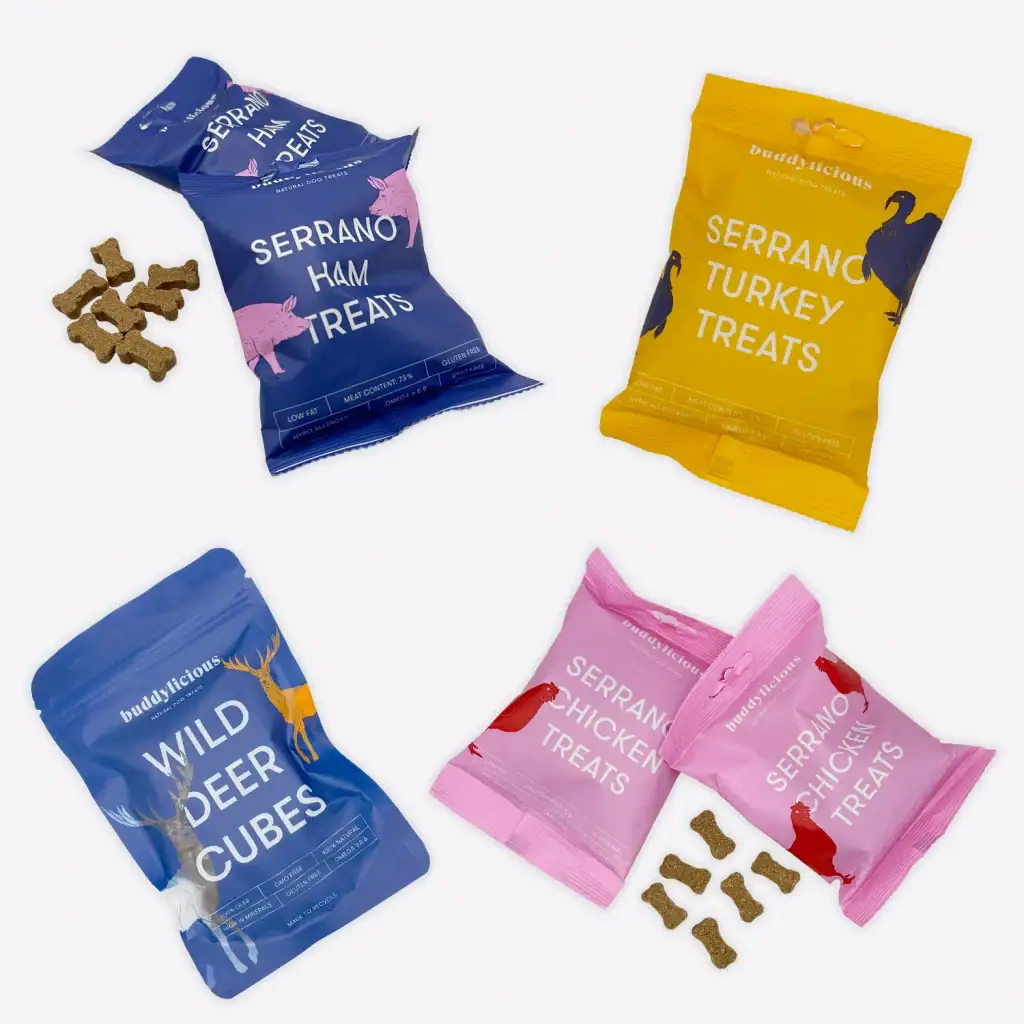 Collage of four Buddylicious dog treat packs in assorted colours.